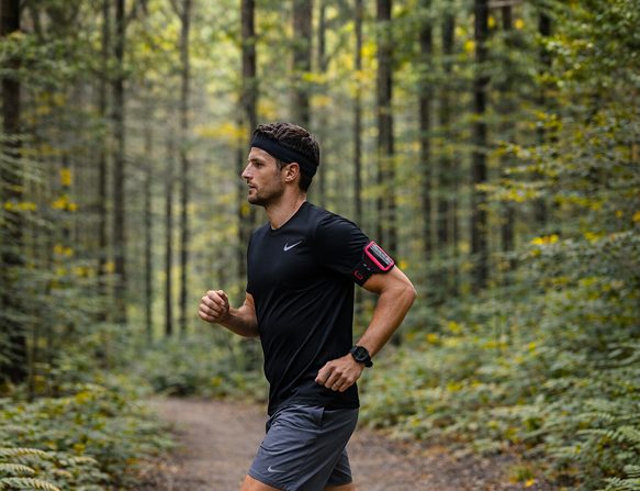 A man running on a forest trail