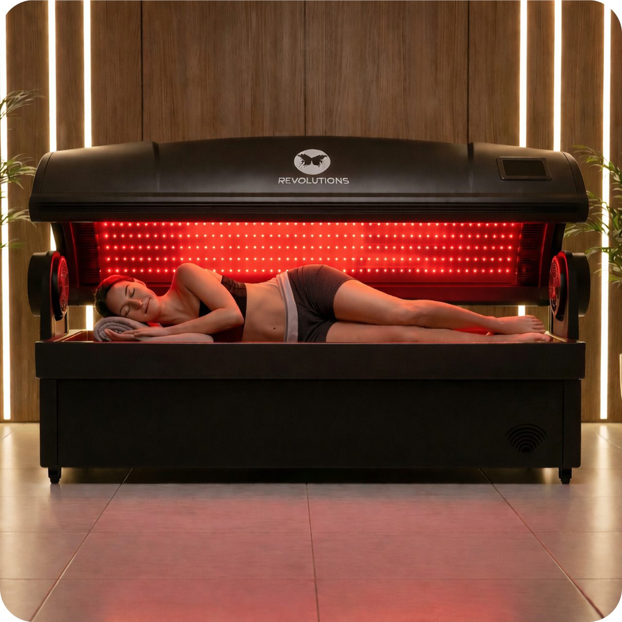 A client resting in the Revolutions full-body red light bed